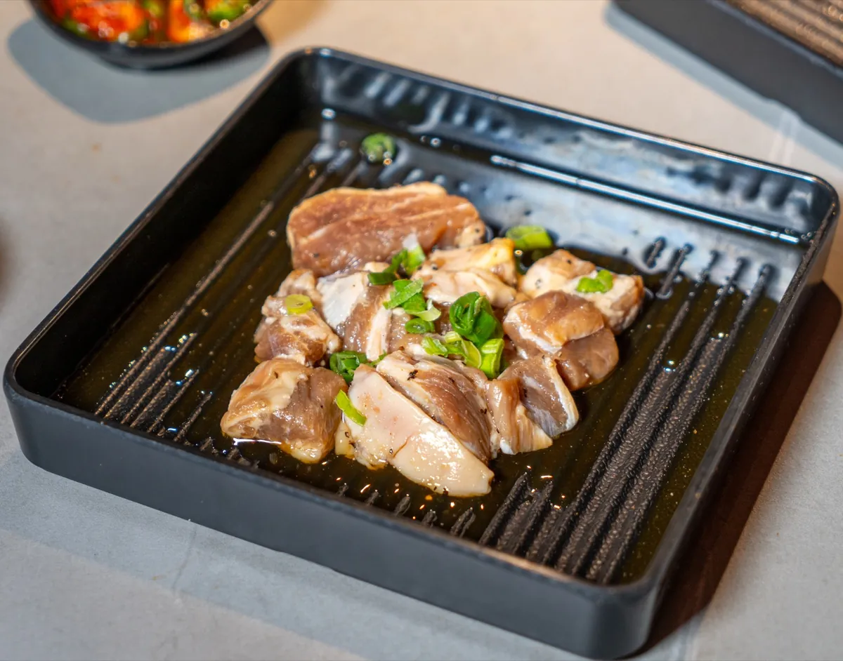 Marinated chicken thigh ready for grill at Kazan BBQ South Gate