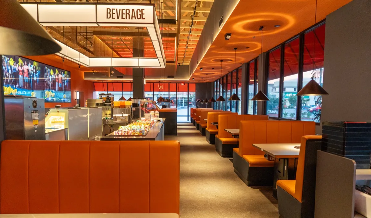 Modern restaurant interior with orange booths at Kazan BBQ South Gate