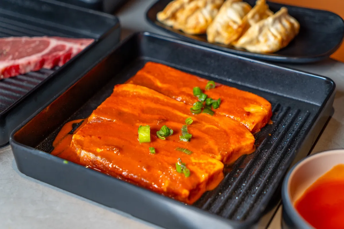 Spicy marinated pork with potstickers at Kazan BBQ